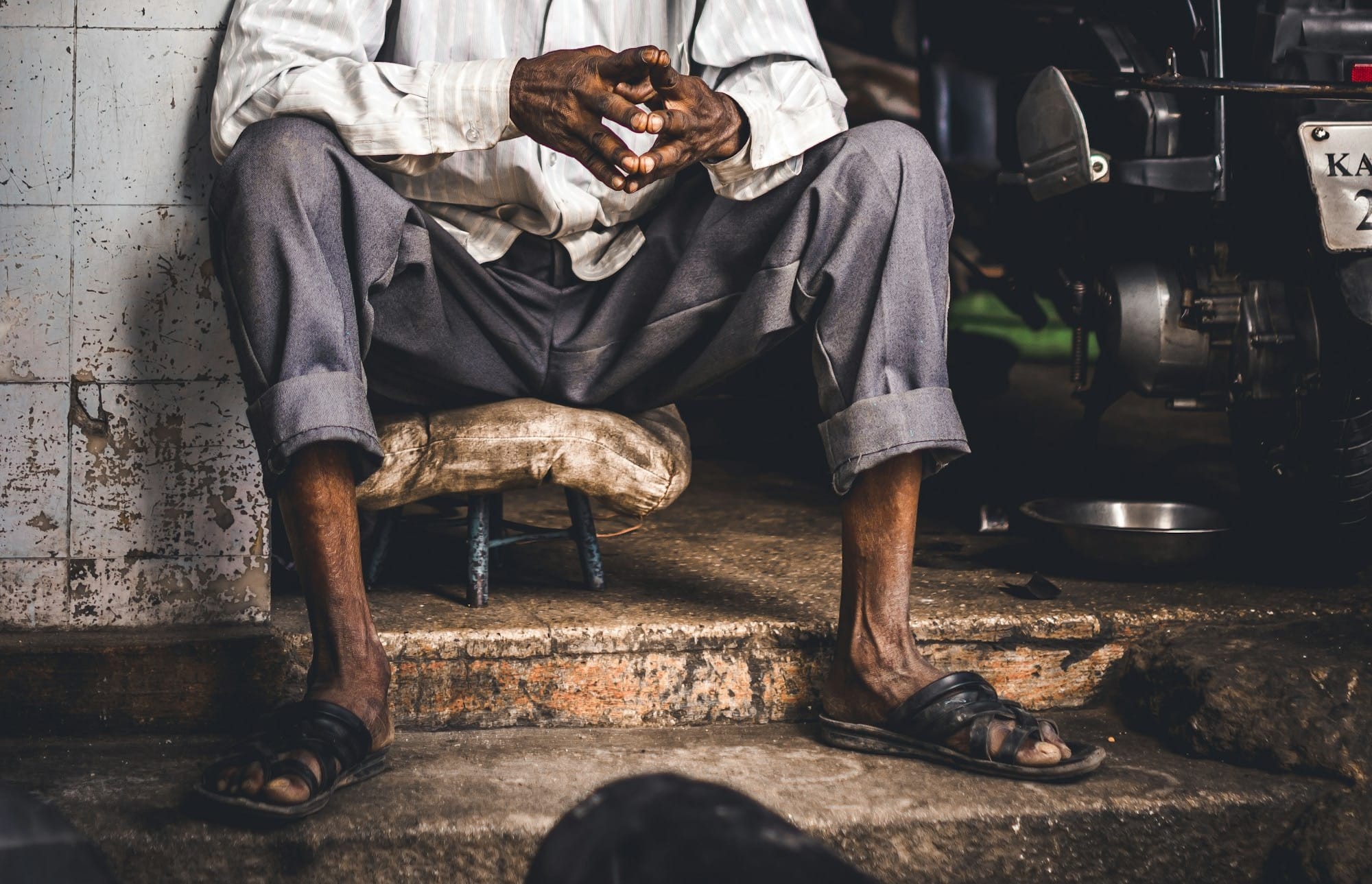 man in white thobe sitting on floor